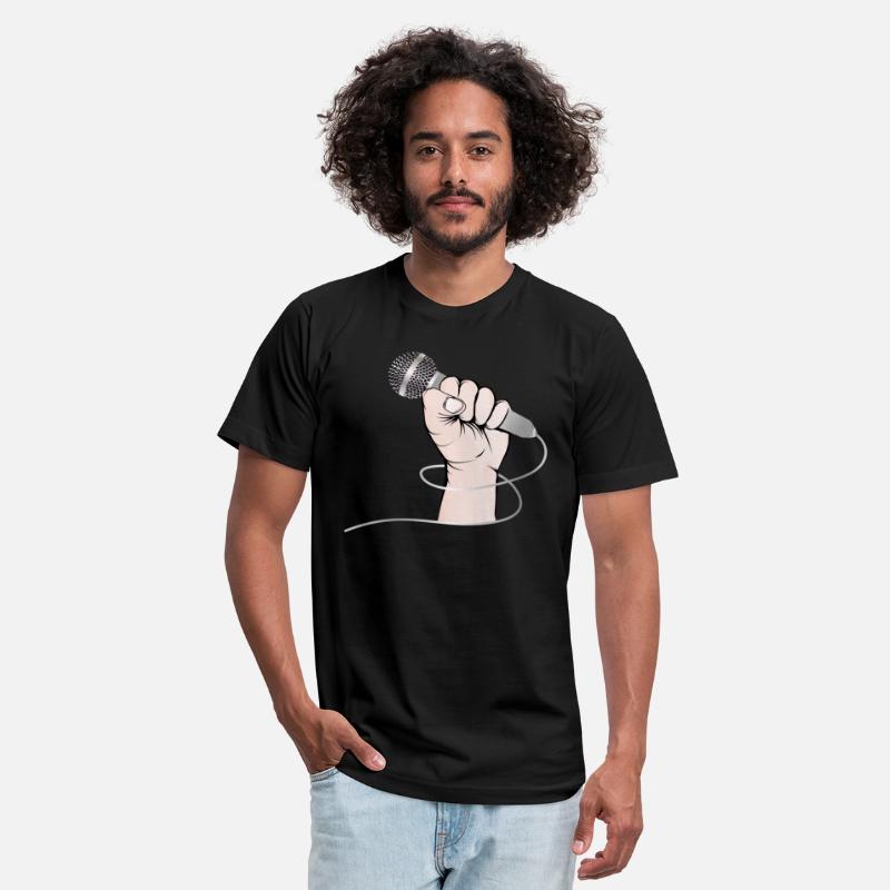 A hand of a singer holds a singing microphone